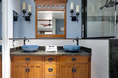 a bathroom with two blue sinks and a mirror at Serene hillside oasis with pool - 20 min to beach in Oceanside