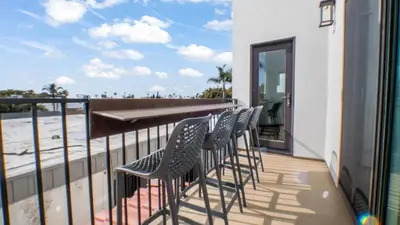 a row of chairs sitting on a balcony at Rise Suites Oceanside in Oceanside