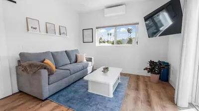a living room with a couch and a table at Rise Suites Oceanside in Oceanside