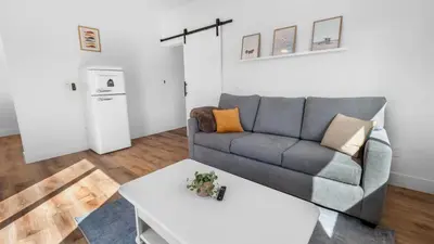 a living room with a couch and a table at Rise Suites Oceanside in Oceanside