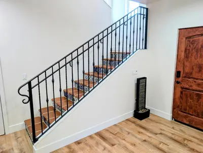 a staircase in a home with white walls at Rise Suites Oceanside in Oceanside