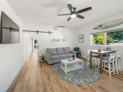 a living room with a couch and a table at Rise Suites Oceanside in Oceanside