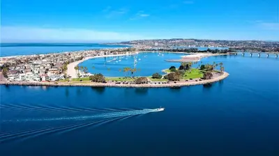 an island in a body of water with a boat at Cozy North Park Townhome in San Diego