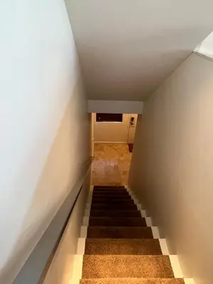 a staircase leading up to a room with white walls at Cozy North Park Townhome in San Diego