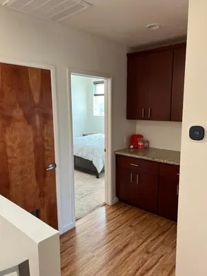 a kitchen with a door leading to a bedroom at Cozy North Park Townhome in San Diego