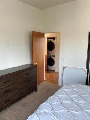 a bedroom with a bed and a washer and dryer at Cozy North Park Townhome in San Diego