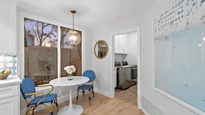 a kitchen with a table and blue chairs in a room at Backyard Oasis w Fire Table Walk to Salt Creek Beach Dana Point Dreams in Dana Point
