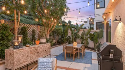 a patio with a table and chairs and a grill at Backyard Oasis w Fire Table Walk to Salt Creek Beach Dana Point Dreams in Dana Point