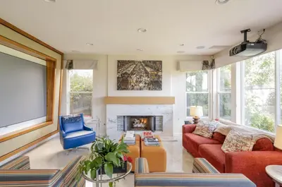 a living room with a couch and a fireplace at Luxe Family Villa ,116 inch Theater, Yard , Near Beaches in San Diego