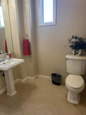 a bathroom with a white toilet and a sink at Luxe Family Villa ,116 inch Theater, Yard , Near Beaches in San Diego