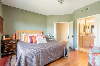 a bedroom with a bed and a dresser and a mirror at Luxe Family Villa ,116 inch Theater, Yard , Near Beaches in San Diego