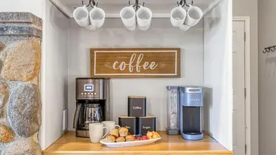 a coffee station with a coffee machine and fruit on a counter at Temecula Wine Country Home w Pool Hot Tub Game Room Vineyard Views in Country Road Estates