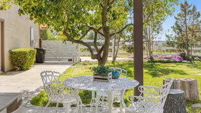 a white table and chairs under a tree at Temecula Wine Country Home w Pool Hot Tub Game Room Vineyard Views in Country Road Estates