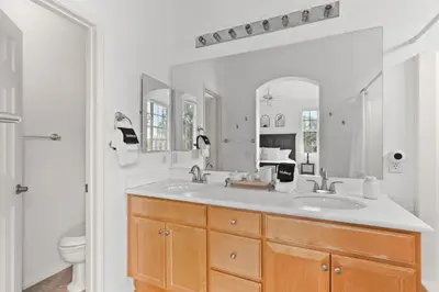 a bathroom with a sink and a toilet and a mirror at Sweet Serenity 3 bed with community pool, spa in Encinitas