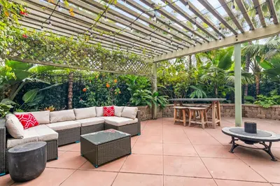 a patio with a couch and a pergola at Sweet Serenity 3 bed with community pool, spa in Encinitas
