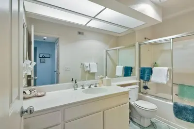 a bathroom with a sink and a toilet and a shower at Nomad's Oceanfront Retreat 2B2B Condo in Oceanside