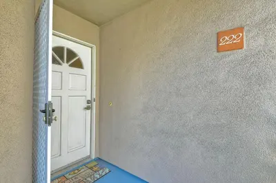 a door in a room with a sign on the wall at Nomad's Oceanfront Retreat 2B2B Condo in Oceanside