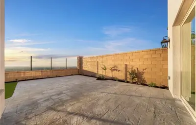 a patio with a brick wall and a building at Hidden Gem New 4B3B House UCI Disney Amazing view in Irvine