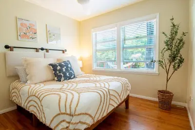 a bedroom with a bed and a window at Ultimate Escape! Huge Yard Parking Walk to Beach in San Diego