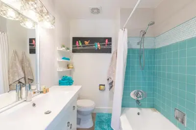 a bathroom with a tub and a toilet and a sink at Scenic View Estate with Pool & Hot Tub in San Diego