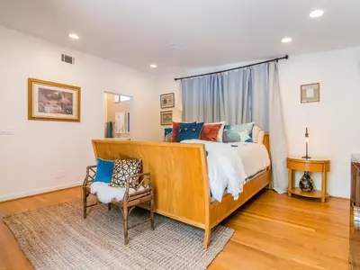 a bedroom with a bed and a chair at La Jolla Condo Oceanview, Zen and Coastal Charm in San Diego