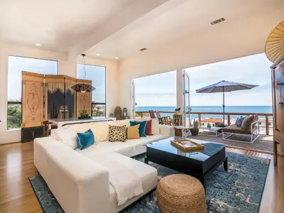 a living room with a white couch and a table at La Jolla Condo Oceanview, Zen and Coastal Charm in San Diego