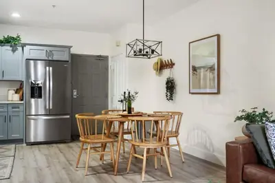 a kitchen with a table and chairs and a refrigerator at Down Town Condo with gym pool BBQ jacuzzi in San Diego