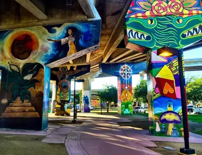 a building with colorful paintings on the side of it at Historic Barrio Logan Bungalow in San Diego