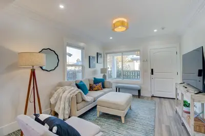 a living room with a couch and a tv at Historic Barrio Logan Bungalow in San Diego