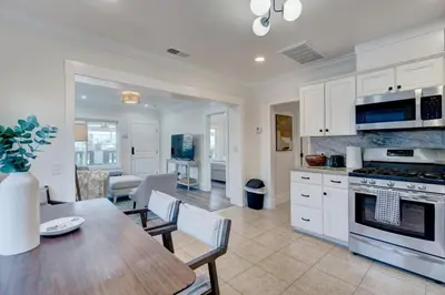 a kitchen and dining room with a table and chairs at Historic Barrio Logan Bungalow in San Diego