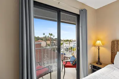 a room with a bed and a balcony with a view at Hidden Gem 3Bed 3Ba Retreat Jacuzzi AC Balconies in San Diego