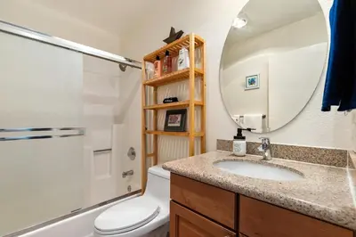 a bathroom with a sink and a toilet and a mirror at Hidden Gem 3Bed 3Ba Retreat Jacuzzi AC Balconies in San Diego