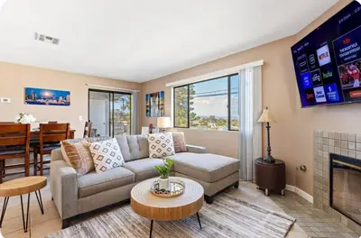 a living room with a couch and a fireplace at Hidden Gem 3Bed 3Ba Retreat Jacuzzi AC Balconies in San Diego
