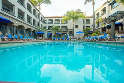 a swimming pool in front of a hotel at Tamarack Beach Hotel in Carlsbad