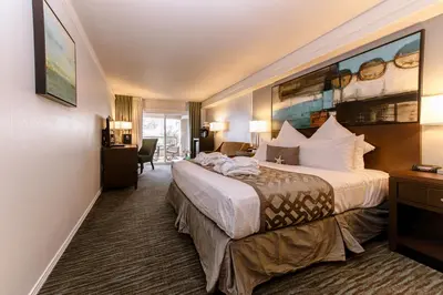 a hotel room with a bed and a large painting on the wall at Tamarack Beach Hotel in Carlsbad