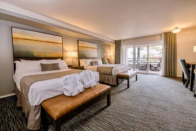 a hotel room with two beds and a balcony at Tamarack Beach Hotel in Carlsbad