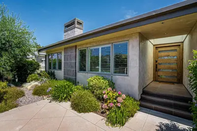 a house with a wooden door and some flowers at La Jolla 3BR Oceanview Deck in San Diego