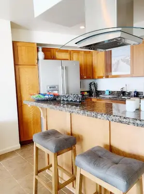 a kitchen with a counter and two stools in it at Sunset Cliffs Oceanfront Oasis, San Diego - Stunning Views & Ocean Sounds in San Diego