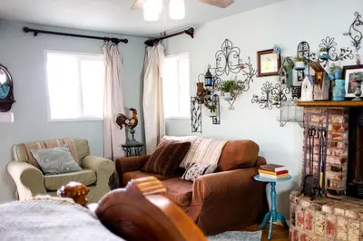 a living room with a couch and a chair at Pet Friendly Breathtaking Cottage with Hot-tub in Rainbow, California in Fallbrook