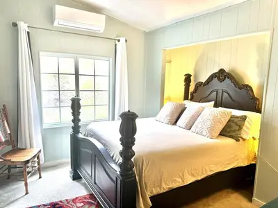 a bedroom with a large bed in a room at Pet Friendly Fantastic Secluded Cottage with Hot-tub in Rainbow, California in Fallbrook