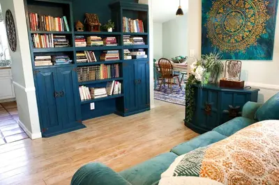 a living room with blue book shelves filled with books at Pet Friendly Fantastic Secluded Cottage with Hot-tub in Rainbow, California in Fallbrook