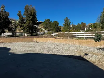 a large yard with a white fence and trees at Temecula Wine Country Villa in Temecula