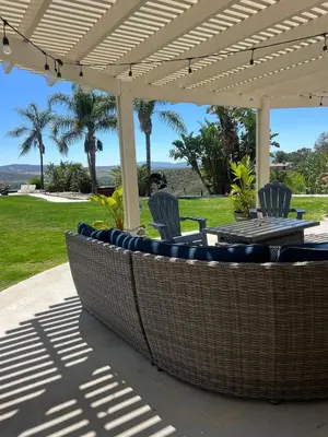 a patio with chairs and a table under a pergola at Temecula Wine Country Villa in Temecula