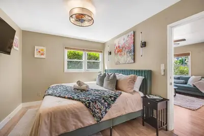 a bedroom with a bed with a cat sitting on it at 1BD Heart of PB Pet Friendly Private Sanctuary in San Diego