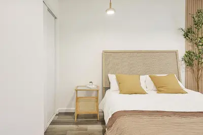 a bedroom with a bed and a side table at Immaculate Home near Balboa Park, SD Zoo, & Cafés in San Diego
