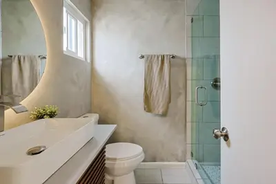 a bathroom with a sink and a toilet and a shower at Immaculate Home near Balboa Park, SD Zoo, & Cafés in San Diego
