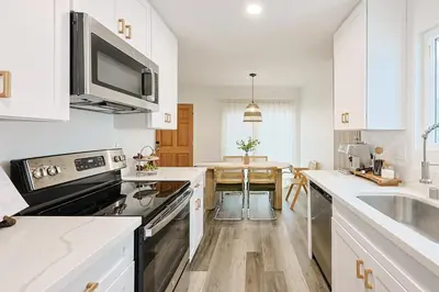 a kitchen with a sink and a stove top oven at Immaculate Home near Balboa Park, SD Zoo, & Cafés in San Diego