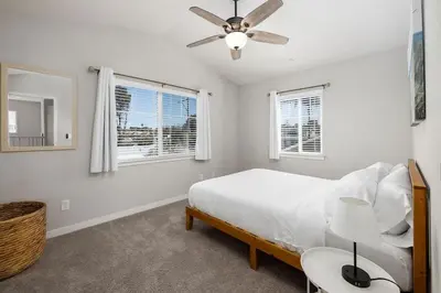 a white bedroom with a bed and a ceiling fan at Large 4 Bedroom Close To Beach in Encinitas