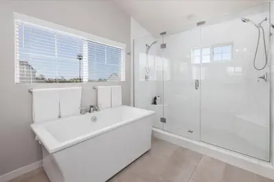 a white bathroom with a sink and a shower at Large 4 Bedroom Close To Beach in Encinitas