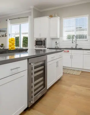 a white kitchen with white cabinets and a sink at Large 4 Bedroom Close To Beach in Encinitas